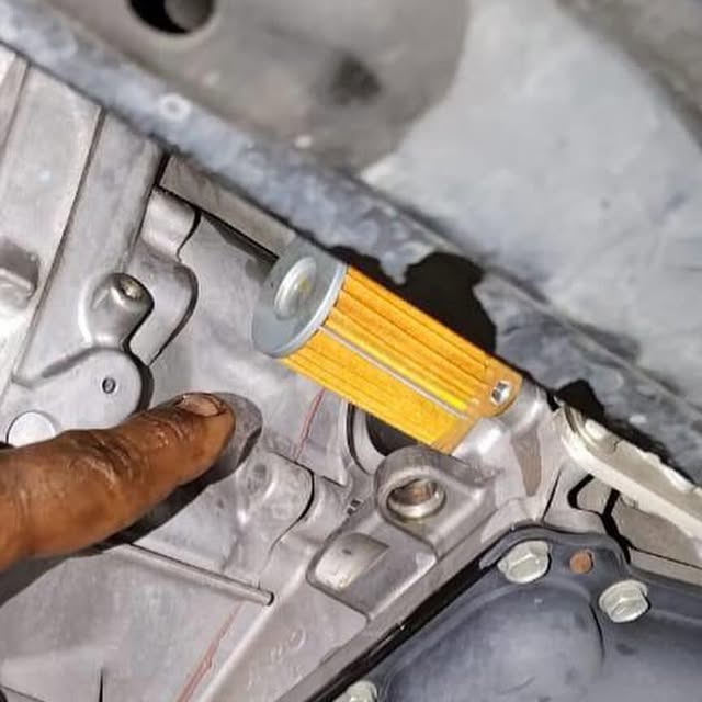 New CVT filter shown during Nissan Teana transmission service