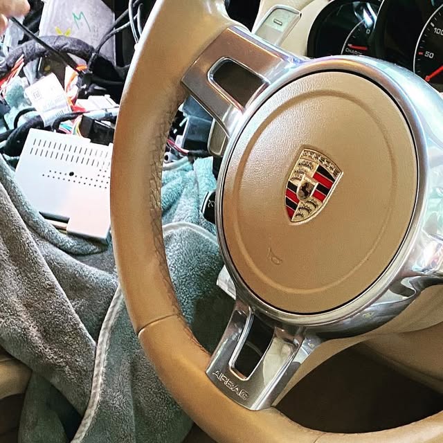 Porsche Cayenne steering wheel during Apple CarPlay installation